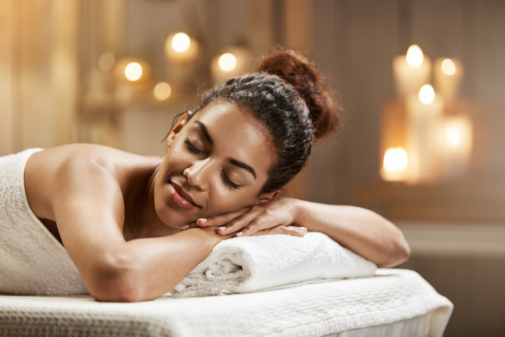 beautiful african girl resting relaxing in spa resort with closed eyes.